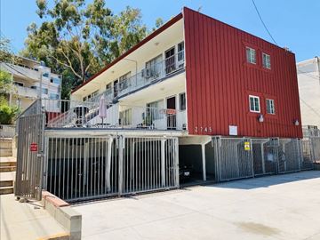 Alhambra multi-family for rent - A red building with a white balcony and a sign that reads 2745.