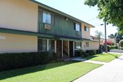 Pomona apartment for rent - A building with a green awning and a white sign on the wall.