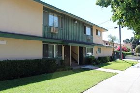 Pomona apartment for rent - A building with a green awning and a white sign on the wall.