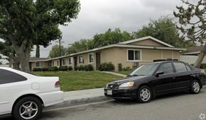 Upland multi-family for rent - Two cars parked in front of a house.
