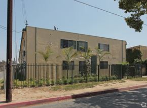 Compton multi-family for rent - A building with a black fence and a bird on top.