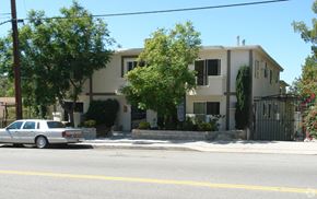 Tujunga multi-family for rent - A white car is parked on the side of the street in front of a house.