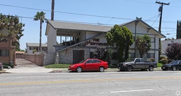 El Monte multi-family for rent - A red car is parked in front of a white building with a sign that says "The Mentor House.".
