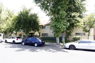 North Hills multi-family for rent - Three cars parked in front of a building.