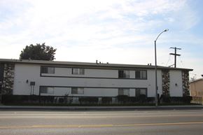 El Monte multi-family for rent - A white building with a black fence in front of it.