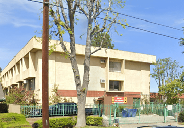 Pico Rivera multi-family for rent - A building with a tree in front of it.