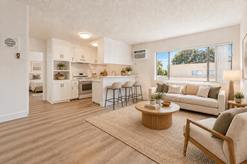 El Monte multi-family for rent - A well-lit, spacious kitchen and living room with wooden flooring and furniture.