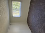 Hemet multi-family for rent - A window with blinds is open, letting in light.