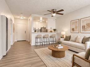 Tujunga multi-family for rent - A living room with a white couch, a coffee table, and a ceiling fan.