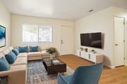 Hemet multi-family for rent - A living room with a sofa, a coffee table, a chair, and a television.