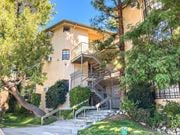 Tujunga multi-family for rent - A building with a staircase and trees in front.