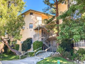 Tujunga multi-family for rent - A building with a staircase and trees in front.