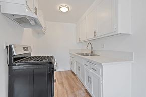 Norwalk apartment for rent - A modern kitchen with white cabinets and a black dishwasher.
