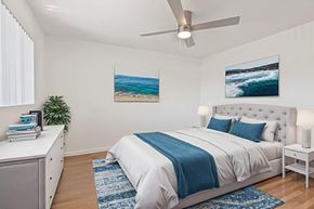 Norwalk apartment for rent - A bedroom with a large bed and a ceiling fan.