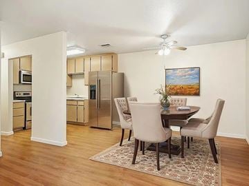 Hemet multi-family for rent - A kitchen with a dining table and chairs.