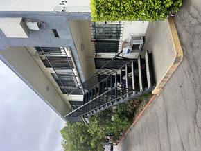 San Fernando multi-family for rent - A building with a staircase and a small tree on top.