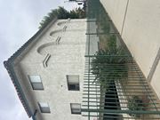Sylmar multi-family for rent - A building with a green fence in front of it.