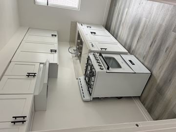 San Fernando multi-family for rent - A white kitchen with a dishwasher and a sink.