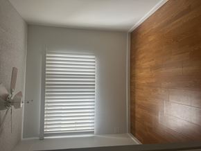 North Hills multi-family for rent - A room with a ceiling fan and wooden wall paneling.