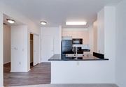 Pomona apartment for rent - a kitchen with a black counter top and a sink at Helix at University Village, Pomona