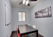 Pomona apartment for rent - a dining room with a black table and red chairs at Helix at University Village, Pomona, 91766