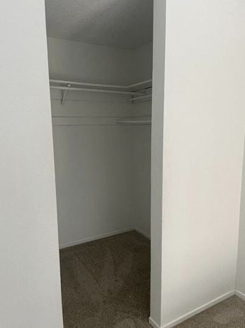 A walk in closet in a bedroom