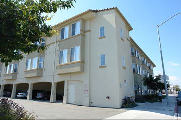Salinas multi-family for rent - A building with a parking garage in front.