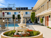 Bellflower multi-family for rent - A fountain in the middle of a courtyard with a building in the background.