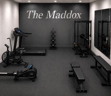 Trenton apartment for rent - A gym with a variety of equipment including treadmills, rowing machines, and weight racks.