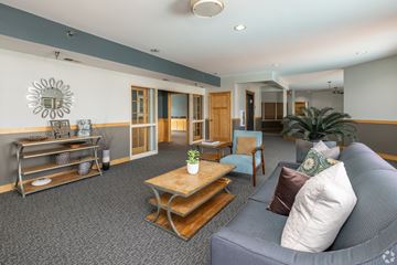 Apple Valley townhouse for rent - A living room with a grey couch and a wooden coffee table.