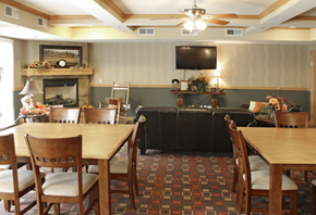 Lakeville apartment for rent - a room with large tables and chairs and a television on the wall
