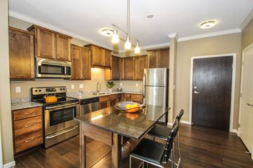 Eagan apartment for rent - a kitchen with wooden cabinets and stainless steel appliances