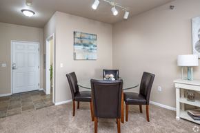 Apple Valley townhouse for rent - A dining room with a glass table and chairs.
