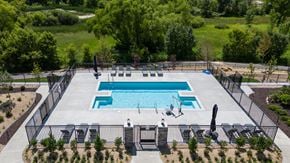 Chaska apartment for rent - an aerial view of a swimming pool with chairs around it