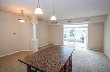 Lakeville apartment for rent - a dining room and living room with a large table and a window