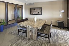 St. Paul apartment for rent - Conference room with rustic wood table and upholstered chairs at Victoria Park and V2 Apartments, St. Paul, 55102