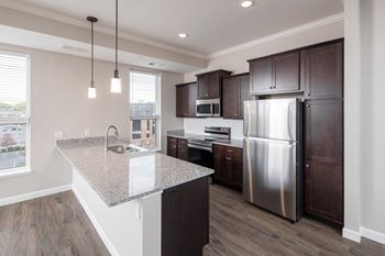 A kitchen with a large island and stainless steel appliances