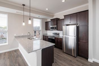 A kitchen with a large island and stainless steel appliances
