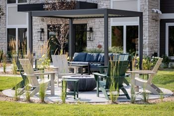 Outdoor patio with pergola and adirondack chairs