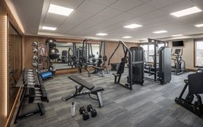 Savage apartment for rent - A well-equipped gym with a variety of exercise machines and weights.
