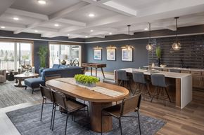 Savage apartment for rent - A modern dining room with a wooden table and chairs.