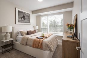 Savage apartment for rent - A bedroom with a bed, nightstand, and a painting on the wall.