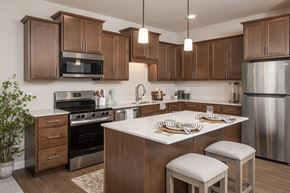 Savage apartment for rent - A kitchen with wooden cabinets and stainless steel appliances.