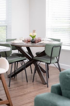 Chaska apartment for rent - a dining room with a wooden table and green chairs