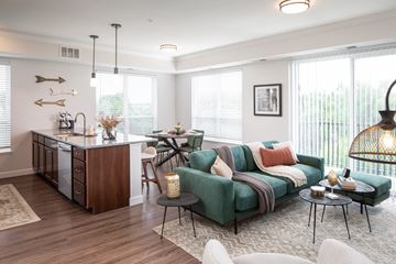 Chaska apartment for rent - a living room with a couch and a kitchen with a table and chairs