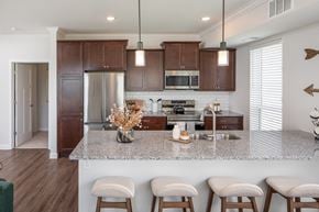 Chaska apartment for rent - a kitchen with wooden cabinets and a marble counter top