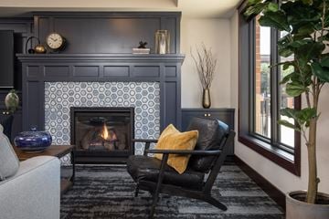 St. Paul apartment for rent - a living room with a fireplace and a chair