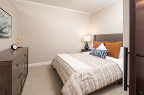 St. Paul apartment for rent - View of model bedroom with bed and dresser  at The Whitley, St. Paul, MN