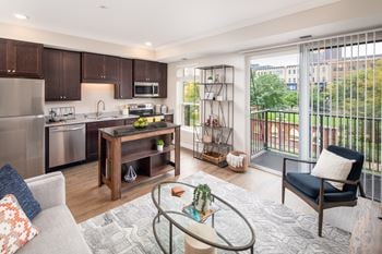 A spacious living room with a kitchen in the background