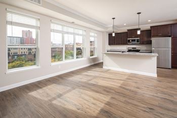 A kitchen and living room with a large window
